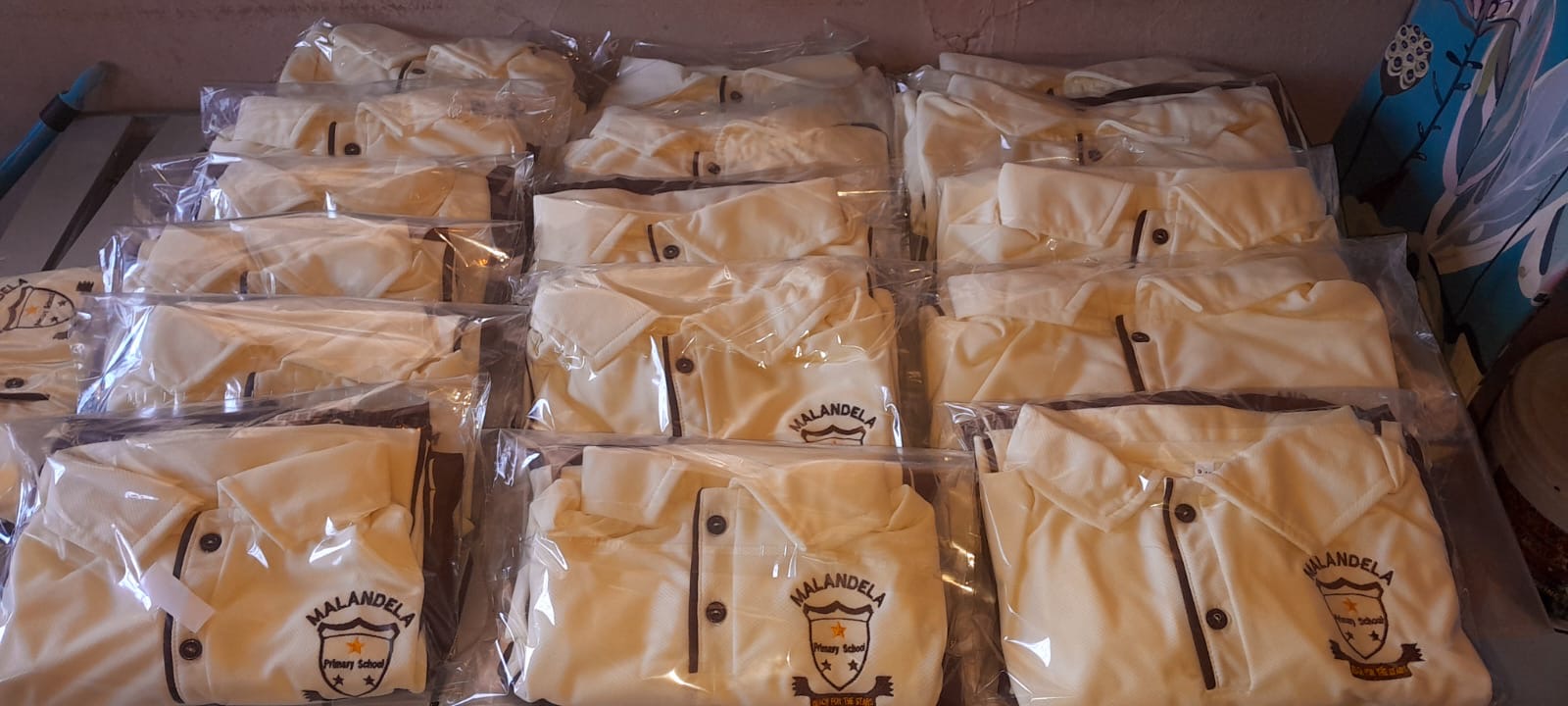 White Malandela Primary School shirts wrapped in plastic